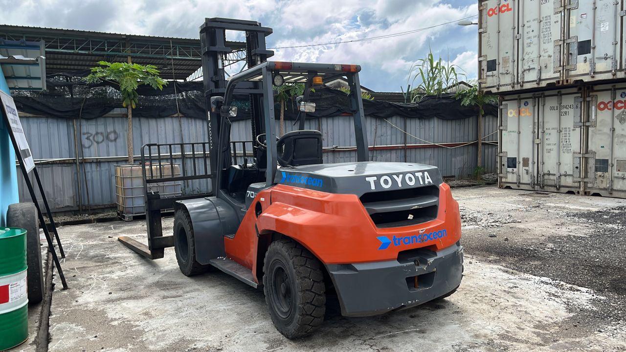 Customized wide carriage forklift for container maintenance.